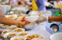 Image of person receiving food from food kitchen