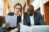 Two people looking over paperword