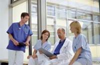 Group of doctors sitting in a modern hospital having a discussion