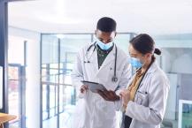 Two young doctors working on a tablet