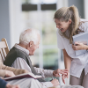 Nurse laughing with an elderly patient