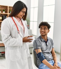 A doctor takes a patient's blood pressure reading.