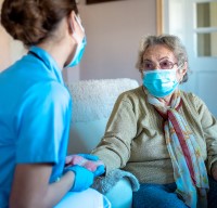 An elderly woman receives a checkup.