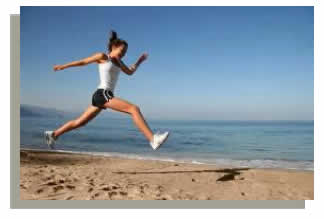 Photograph shows a woman running on the beach